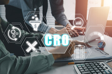 CRO, Conversion Rate Optimization concept, Business team analyzing income charts and graphs on desk with Conversion Rate Optimization icon on virtual screen.