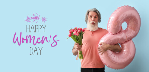 Surprised senior man holding tulips and balloon in shape of figure 8 on blue background....