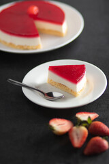 cheesecake and strawberries on a black background