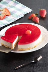 cheesecake and strawberries on a black background