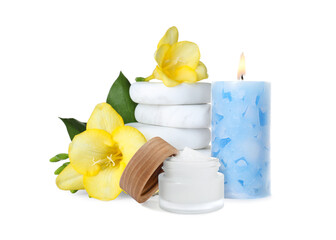 Beautiful composition with jar of body cream, flowers, stones and burning candle on white background. Spa therapy