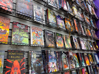 Obraz premium Lynnwood, WA USA - circa January 2023: Close up view of popular comics for sale inside a Phantom Zone Comics store.