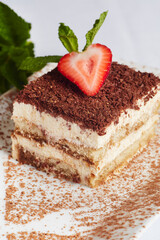 Delicious Tiramisu dessert with a strawberry on top. Food photography.
