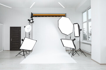Interior of modern photo studio with professional lighting equipment