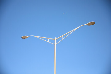 Street lamps during evening lighting up urban