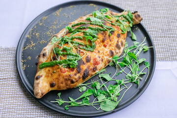 Rolled pizza with filling, crispy and full of cheese and salami.