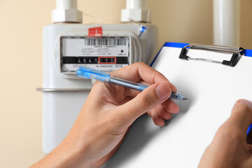 Man filling in gas receipt near counter, closeup