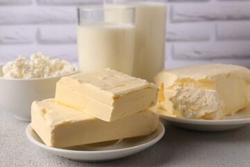 Tasty homemade butter and dairy products on white textured table