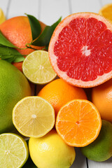 Fototapeta na wymiar Different citrus fruits with fresh leaves, closeup