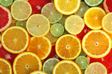 Different citrus fruits as background, top view
