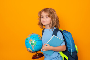 Knowledge day. Isolated portrait of cute child school boy. School and education kids concept. Clever school boy with school supplies on yellow studio background.