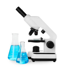 Laboratory glassware with light blue liquid and microscope isolated on white