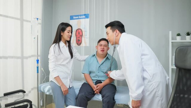 Asian young man and mother visit and consult health problem with doctor.