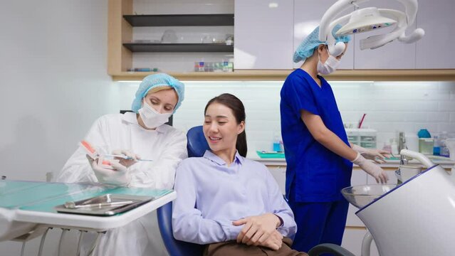 Caucasian dentist examine tooth for young girl at dental health clinic.