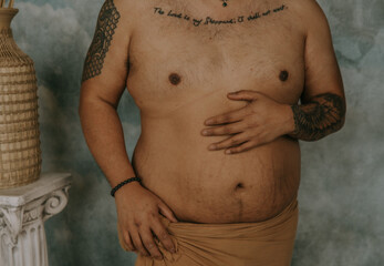 plus size Filipino man's torso with hand on belly