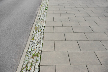 View on sidewalk near road. Footpath covering