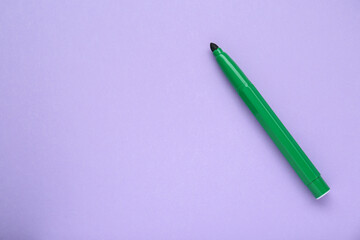 Green marker on light background, top view. Space for text