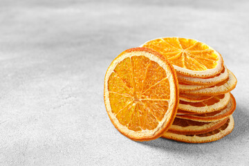 Dry orange slices on light grey table, space for text