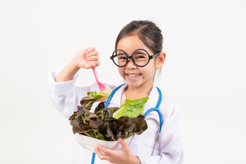 Asia little girl playing doctor recommends vegetables and fruits for proper nutrition and benefits to your health isolated on white