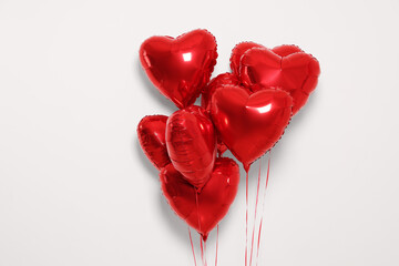 Many red heart shaped balloons on white background