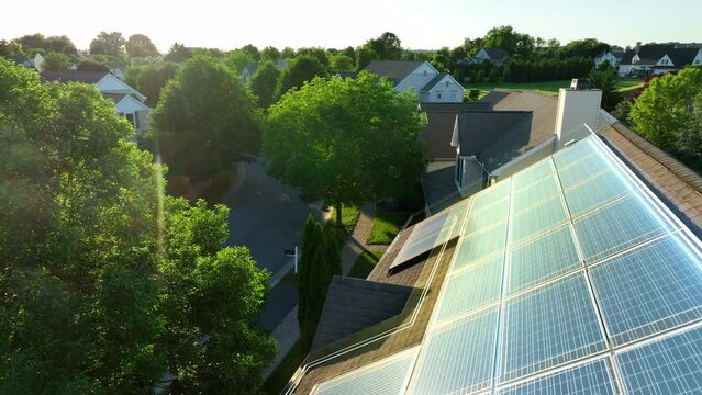 Solar panels on residential home in America. 3D animation on aerial shot of sun reflection on photovoltaic array. Renewable, green energy in futuristic neighborhood.