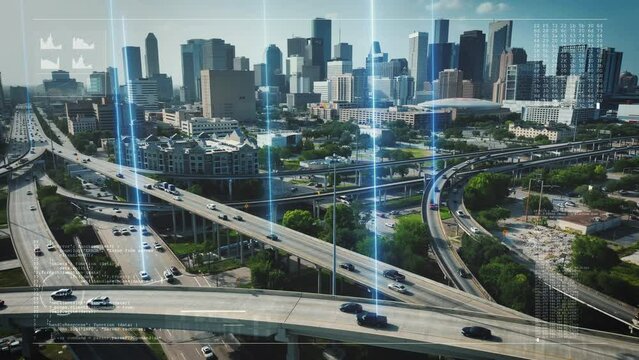 Autonomous cars on highway with traffic in Houston, Texas. Aerial reverse dolly with animation motion graphic of code, graphs, and tracking of self driving cars. Futuristic driving and city theme.