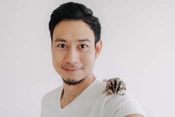 Happy Asian man with his pet Sugar Glider on his shoulder.