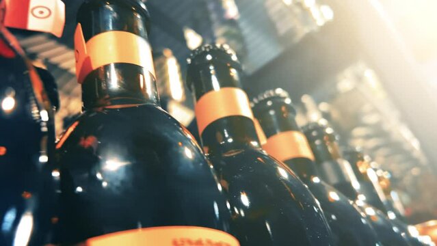 Apple cider in dark glass bottles stands on the shelves of an ABC store, liquor store or supermarket