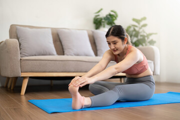 Obraz na płótnie Canvas Young woman doing health exercises at home