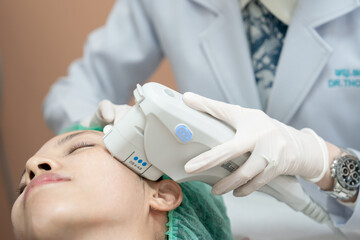 Beautician procedure by electric device,Ultrasound therapy treatment for skin tightening in...