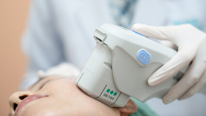 Beautician procedure by electric device,Ultrasound therapy treatment for skin tightening in aesthetic clinic.
