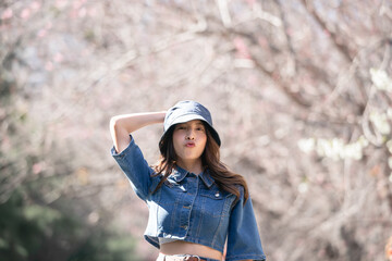 Woman with cherry blossoms or sakura flower blooming in the park