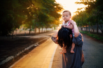 Asian baby and mom on park 