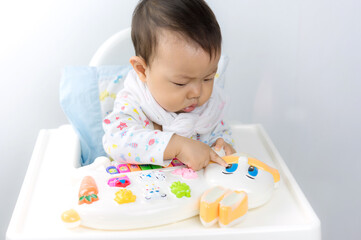 Baby sitting play in high chair,happiness baby,asian baby boy