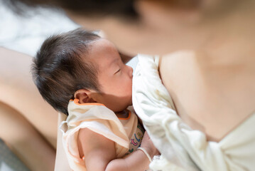 mother breastfeeding her baby toddler