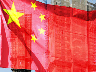 Double exposure creative hologram of unfinished supertall building and Chinese flag