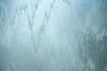 Falling water on glass wall , blurred background.