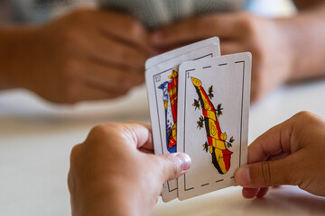 person play on a paper card truco as de basto