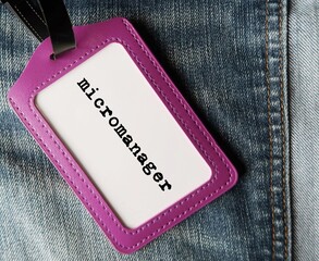 Purple ID card holder with text written MICROMANAGER refer to a boss or manager who gives excessive...