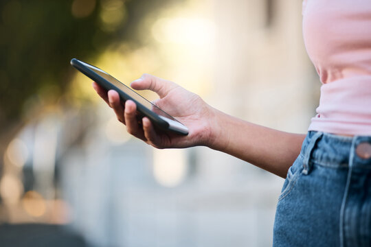 Phone, woman hand and mobile networking of a person doing urban travel with 5g connection. Digital gps, hand and zoom of a young person on social media or reading a text with blurred background - Powered by Adobe