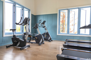 Fototapeta na wymiar Treadmills set in gym interior. Fitness club with equipment. Sports background with glass windows