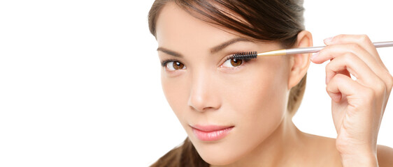 Beauty makeup woman putting mascara eye make up on eyes. Asian fresh face girl looking in the...
