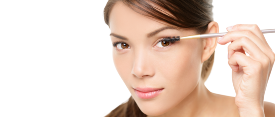 Beauty makeup woman putting mascara eye make up on eyes. Asian fresh face girl looking in the mirror looking at camera isolated in transparent PNG. Mixed race ethnic Asian Chinese / Caucasian model.