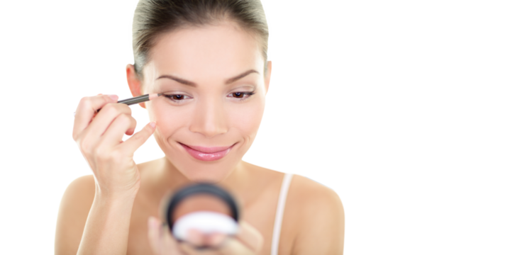 Eyeliner eye makeup beauty care woman. Asian girl putting eye pencil color on eyes looking in a pocket mirror smiling happy isolated in transparent PNG. Make up with multiracial Asian Caucasian girl.