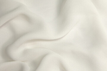 White fabric background. White cloth waves background texture. White fabric cloth textile material.