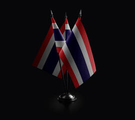 Small national flags of the Thailand on a black background