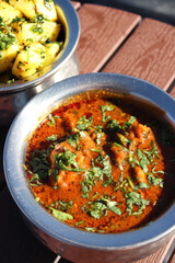hicken curry. Pahadi chicken masala is a famous Spicy nonvegetarian dish of north India. It's made out of chicken meat along with spices and garnished with fresh coriander. copy space.