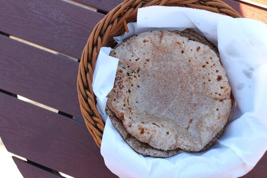 Ragi roti or flat Bread made using finger millet is a healthy food choice. served in a roti basket with ghee. copy space. 