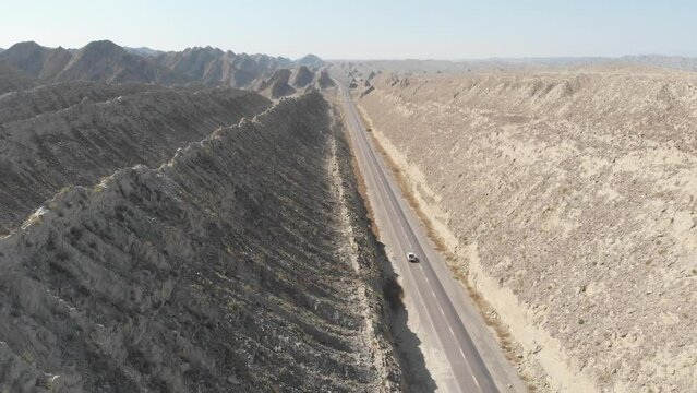 Aerial Flying Over N10 Makran Coastal Highway Road Beside Dramatic Rock Formations In Hingol National Park. Dolly Forward