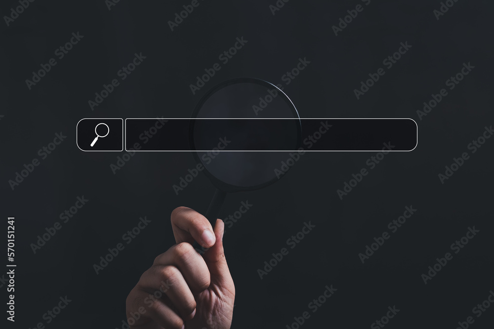 Wall mural hand holding magnifying glass. searching for information. using search console with your website. da
